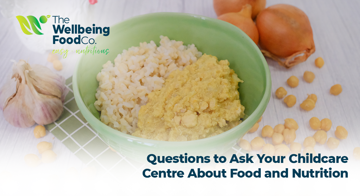 Parent and childcare educator sitting at a table discussing children’s food and nutrition.