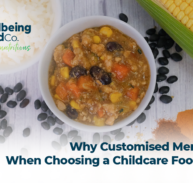 Smiling young children around a table enjoying colourful, nutritious meals together, illustrating healthy childcare catering and custom menu options.